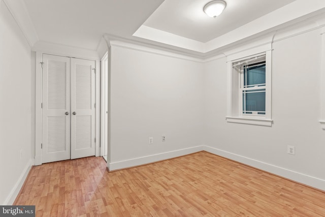 spare room with crown molding and hardwood / wood-style floors