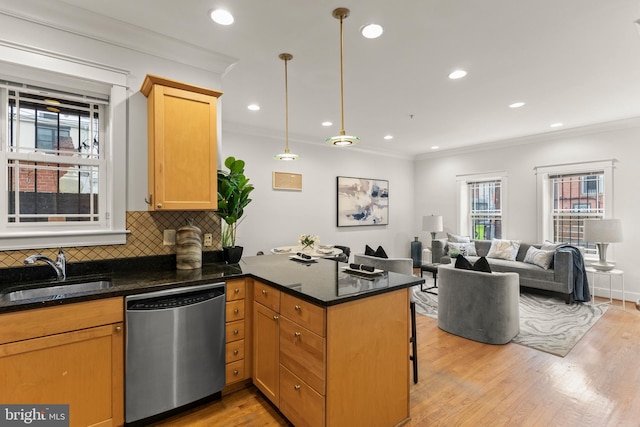 kitchen featuring kitchen peninsula, sink, decorative light fixtures, dishwasher, and light hardwood / wood-style floors