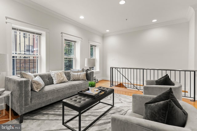 living room featuring light wood-type flooring and ornamental molding