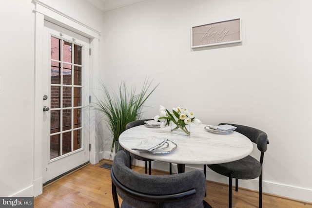 dining space with light hardwood / wood-style flooring