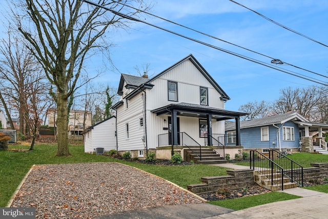 view of front of property with central AC unit, a porch, and a front yard