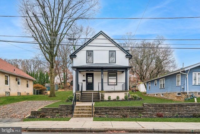 view of front of property with covered porch and a front lawn