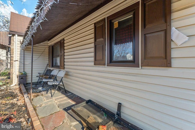 view of side of property featuring covered porch