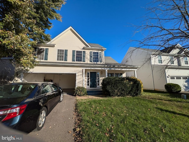 front facade featuring a garage and a front yard