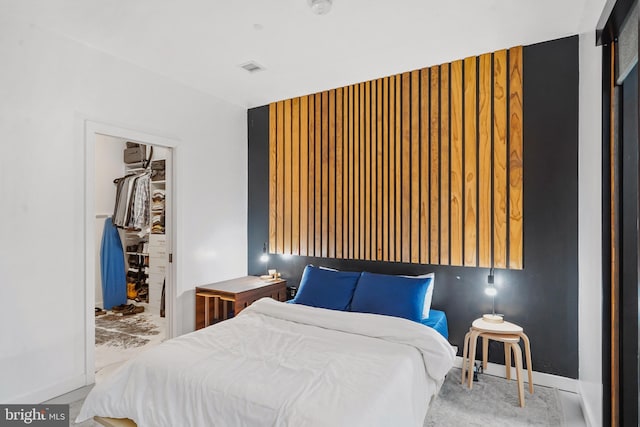 bedroom featuring a walk in closet and a closet