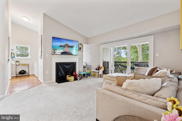 carpeted living room featuring lofted ceiling