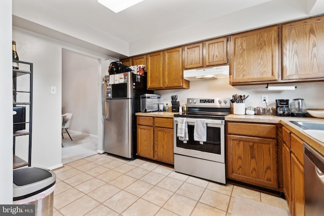 kitchen with light tile patterned floors and appliances with stainless steel finishes