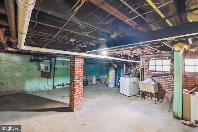 basement featuring washer / dryer, sink, electric panel, and water heater