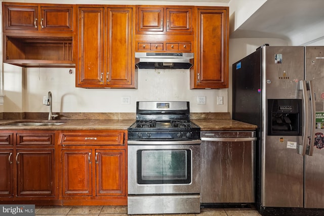 kitchen featuring light tile patterned flooring, stainless steel appliances, and sink