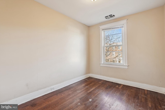 unfurnished room with dark hardwood / wood-style floors