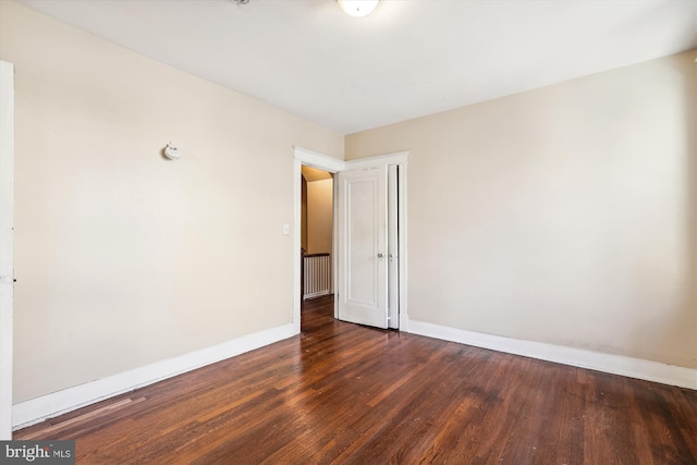 unfurnished room featuring dark hardwood / wood-style floors