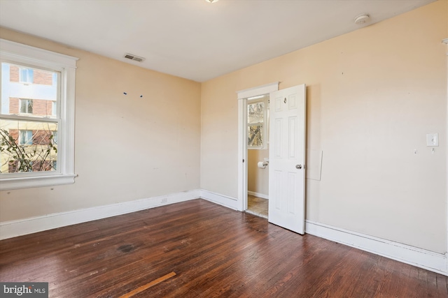 spare room featuring dark wood-type flooring