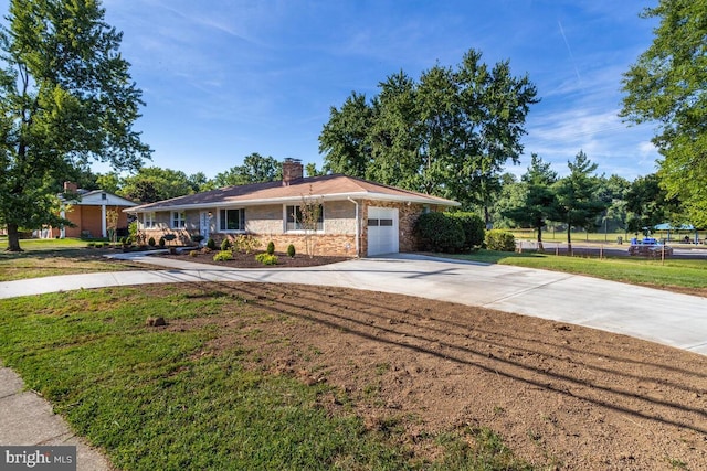 ranch-style house with brick siding, a chimney, a front yard, a garage, and driveway