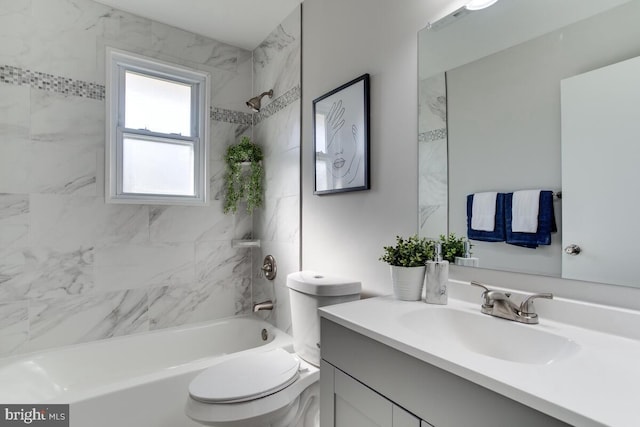 bathroom featuring toilet, bathtub / shower combination, and vanity