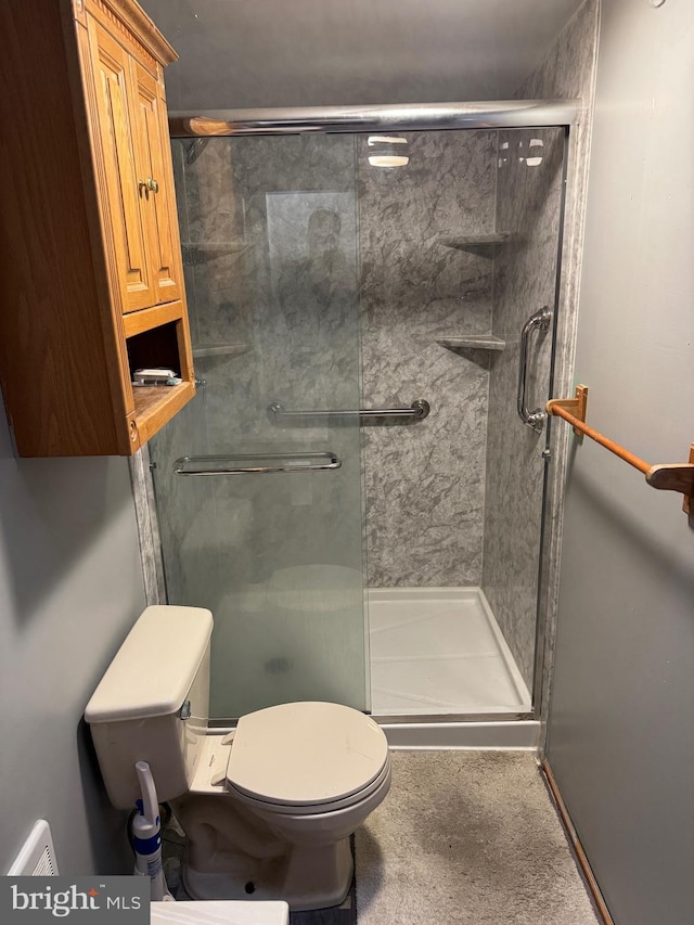 bathroom with an enclosed shower and toilet