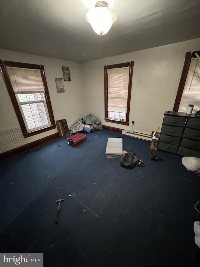 unfurnished bedroom featuring a baseboard heating unit