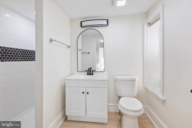 bathroom featuring hardwood / wood-style floors, vanity, and toilet