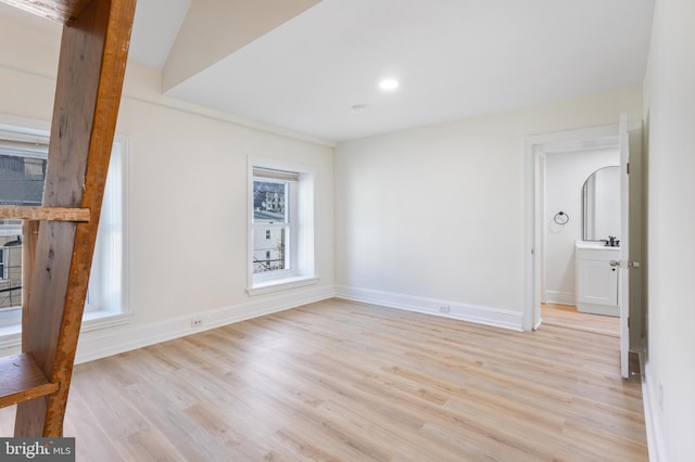 interior space with vaulted ceiling and light hardwood / wood-style flooring