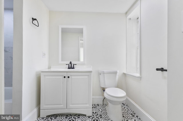 bathroom with tile patterned flooring, vanity, and toilet