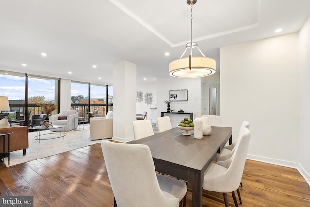 dining area with floor to ceiling windows and dark wood-type flooring