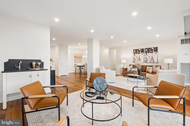 living room featuring light hardwood / wood-style flooring and sink