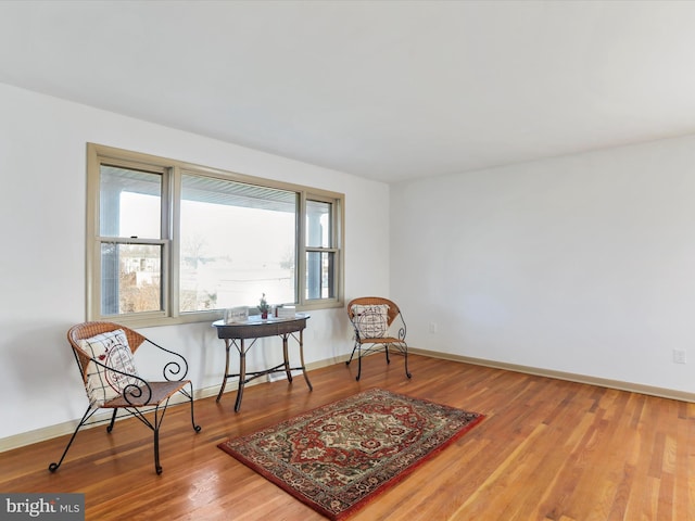 living area with hardwood / wood-style flooring