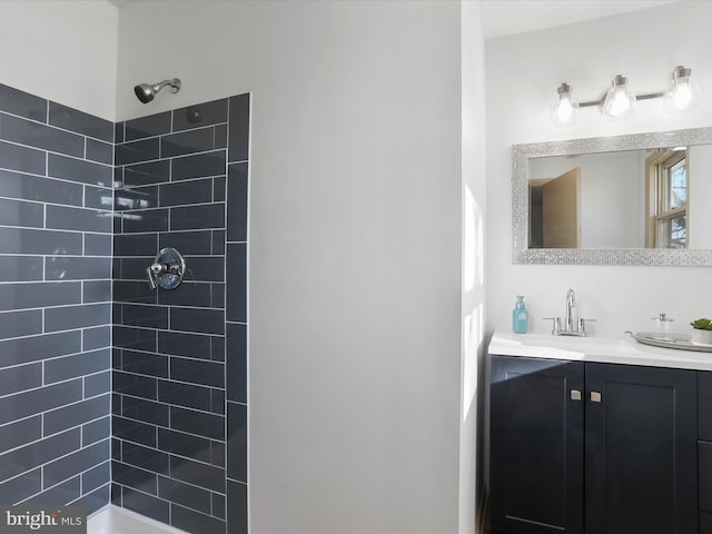 bathroom with vanity and tiled shower