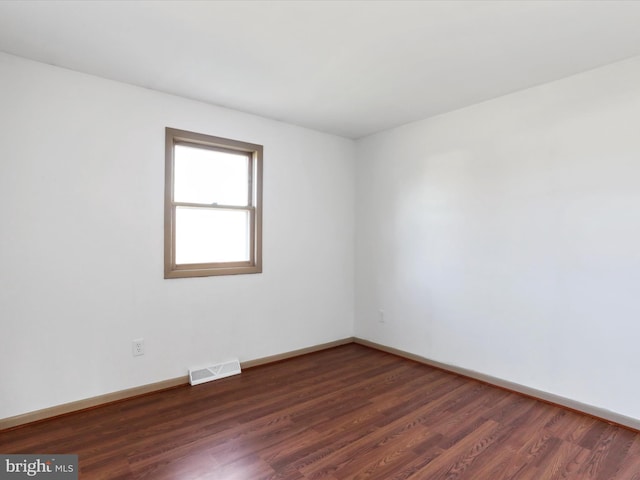 unfurnished room featuring dark hardwood / wood-style floors