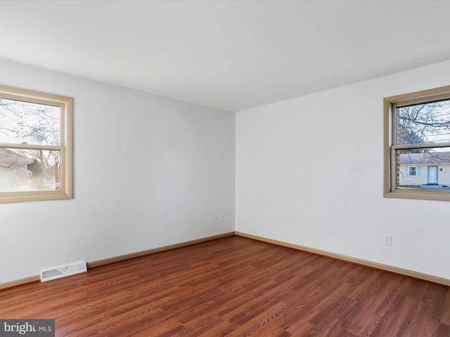 spare room featuring dark hardwood / wood-style floors