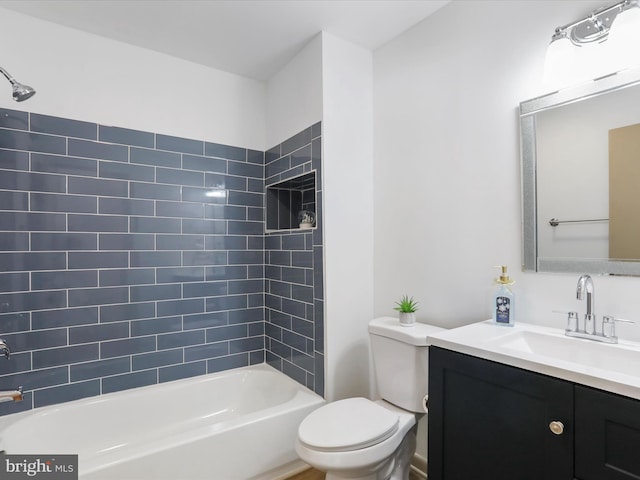 full bathroom featuring toilet, vanity, and tiled shower / bath