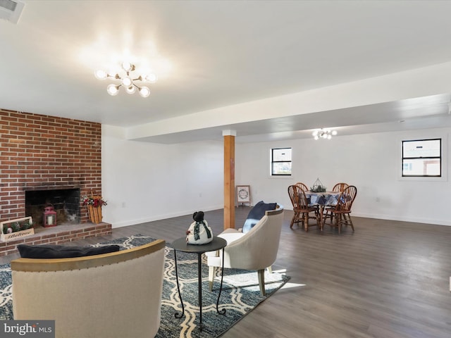 living room featuring dark hardwood / wood-style floors and a brick fireplace