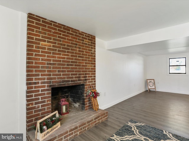 unfurnished living room featuring dark hardwood / wood-style floors and a fireplace