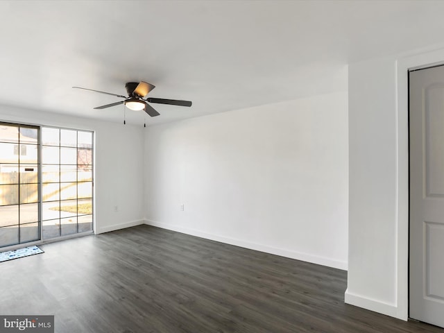 empty room featuring ceiling fan and dark wood-type flooring