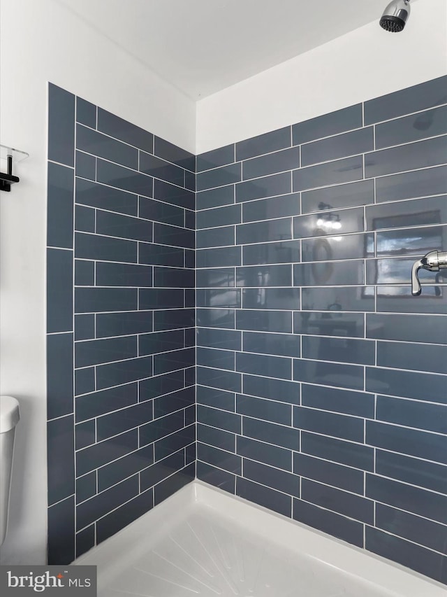 bathroom with tiled shower