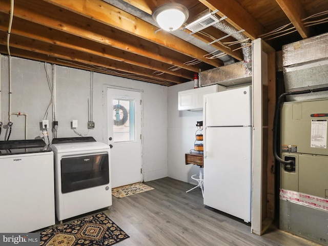 laundry room with washer and clothes dryer and hardwood / wood-style floors