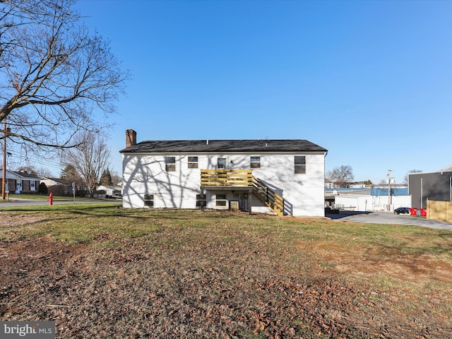 rear view of house featuring a yard