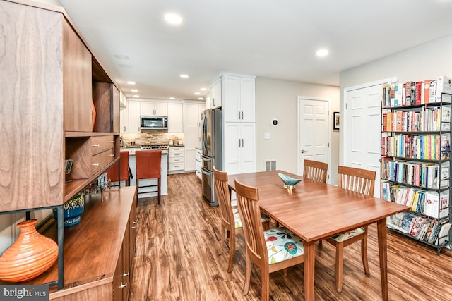 dining space with light wood-type flooring