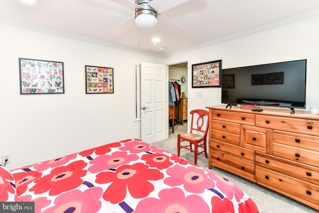 bedroom with crown molding, a closet, ceiling fan, and a spacious closet