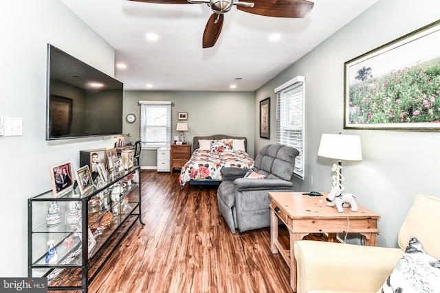 bedroom with ceiling fan, hardwood / wood-style floors, and multiple windows