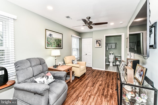 living room featuring dark hardwood / wood-style floors and ceiling fan