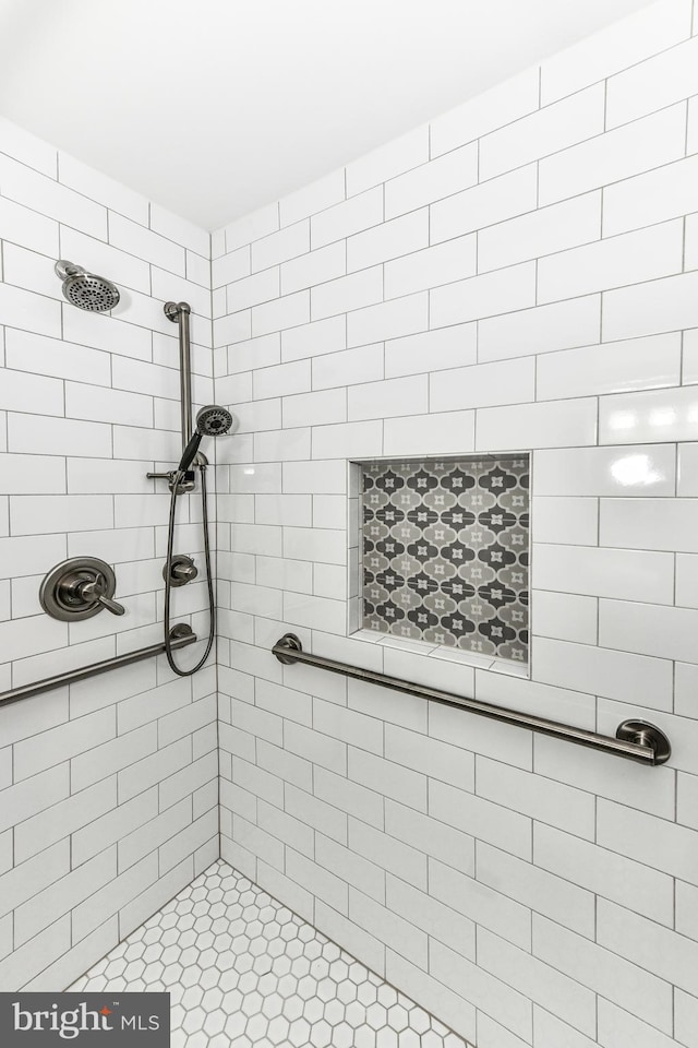 bathroom with a tile shower