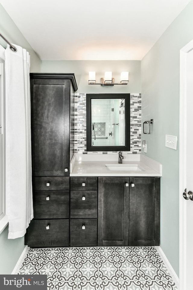 bathroom with tasteful backsplash, vanity, and tile patterned flooring