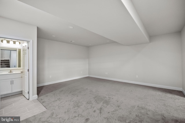 interior space featuring sink and light carpet