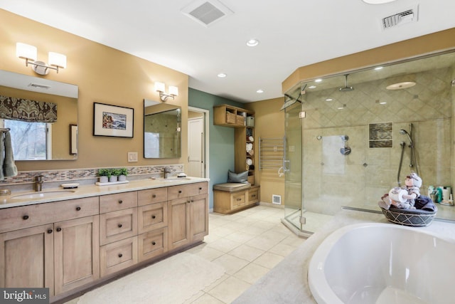 bathroom featuring tile patterned floors, plus walk in shower, and vanity