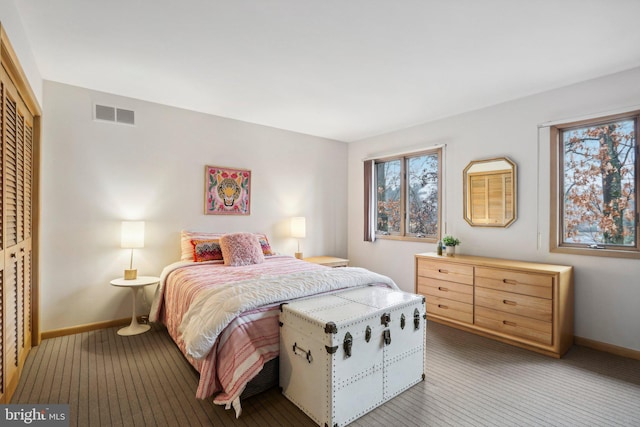 bedroom with carpet flooring and a closet