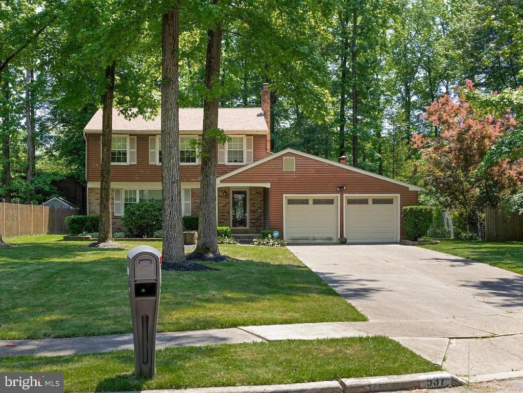 view of front of property with a front lawn and a garage