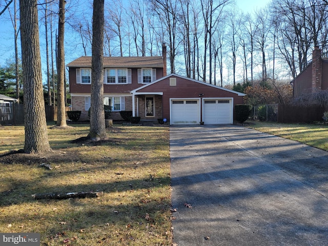 view of front of home with a front yard and a garage