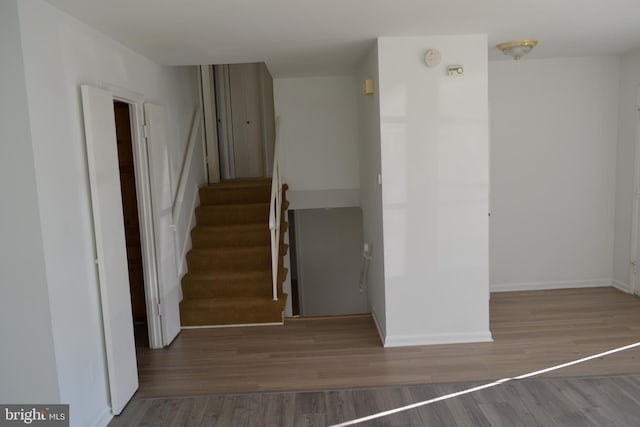 staircase with hardwood / wood-style floors