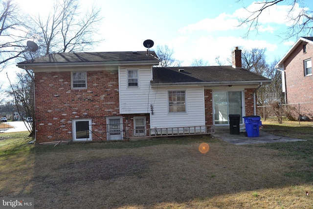 rear view of property featuring a yard