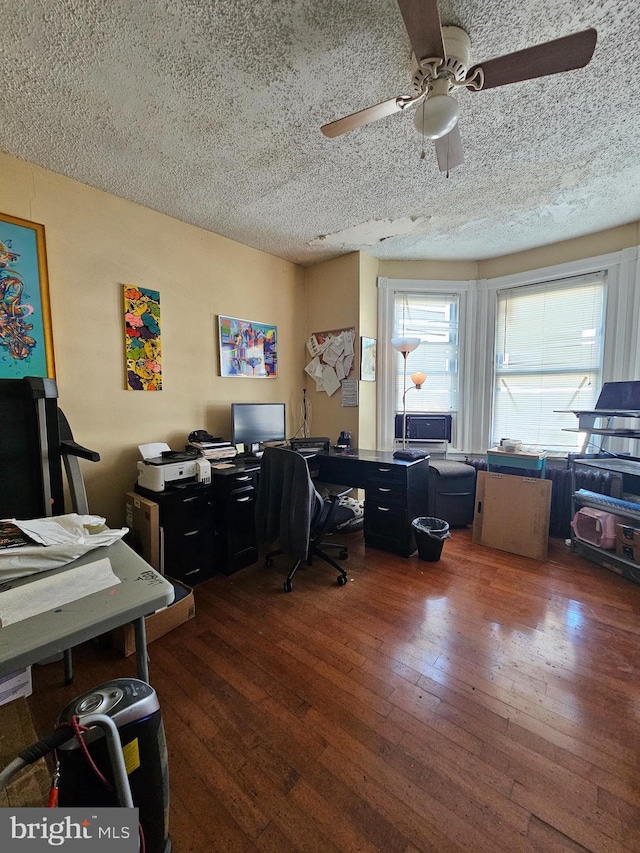 office area featuring ceiling fan, dark hardwood / wood-style flooring, and a textured ceiling